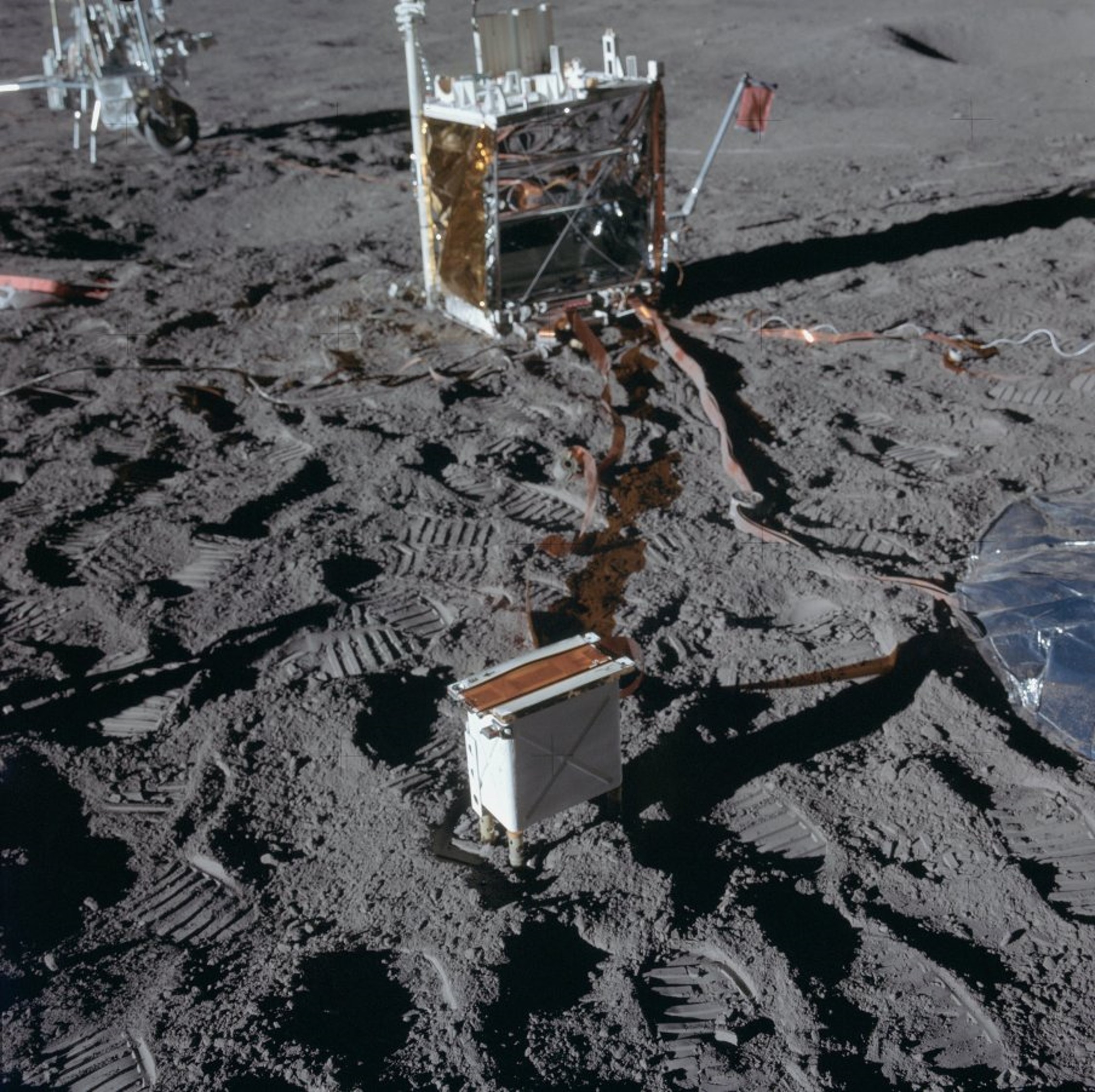 The Charged Particle Lunar Environment Experiment is in the foreground.   O’Brien’s tiny dust detector is the small white box on the upper right-hand corner of the Apollo Lunar Surface Experiments Package central station in the background. 