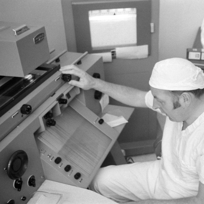 Dr. Ross Taylor reviewing preliminary data from the optical emission spectrograph in the Spectrographic Laboratory of the Physical-Chemical Test Laboratory. 