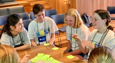 School kids around table in an engaging conversation