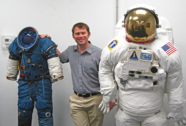 Dr James Waldie, Human Aerospace Director, with NASA Extravehicular Activity suits used for spacewalking.