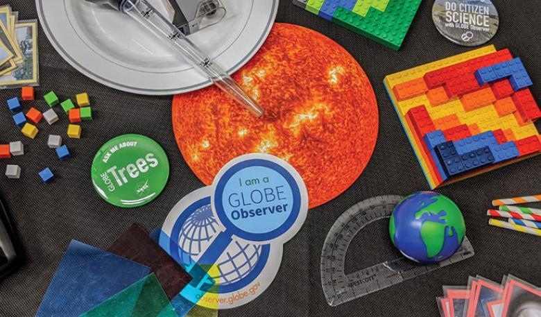 Photo of craft materials including a sticker saying I am a GLOBE observer.