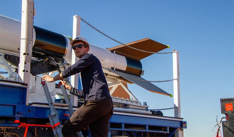 Photo of Nick McLean, Propulsion Engineer, working on a rocket.