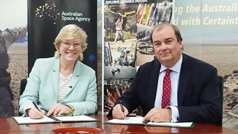 Photo of Dr Megan Clark AC and Mr Philippe Odouard, Managing Director of XTEK signing papers.