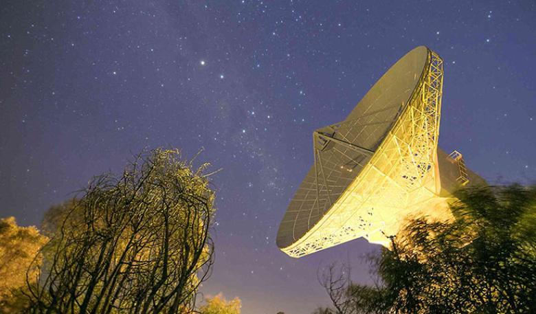 A deep space antenna with the night sky behind