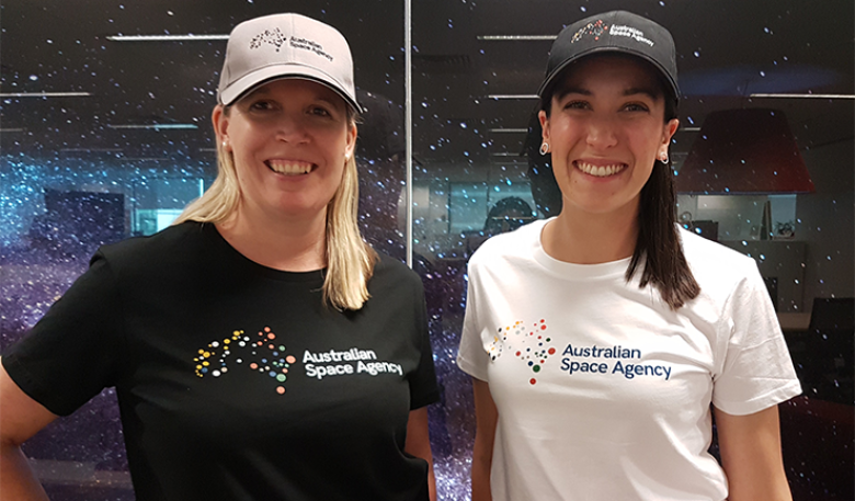 Photo of two women wearing Australian Space Agency t-shirt featuring the brand