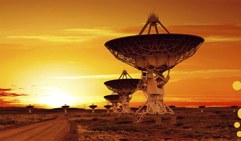 Photo of multiple radio astronomy observatories dishes in outback sunset.