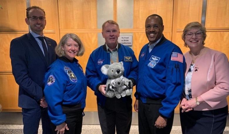 The Australian Space Agency team holding the stuffed toy koala and joey in the Australian Space Agency foyer.