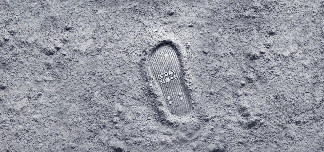 Boot print on moon with gday moon text within boot print