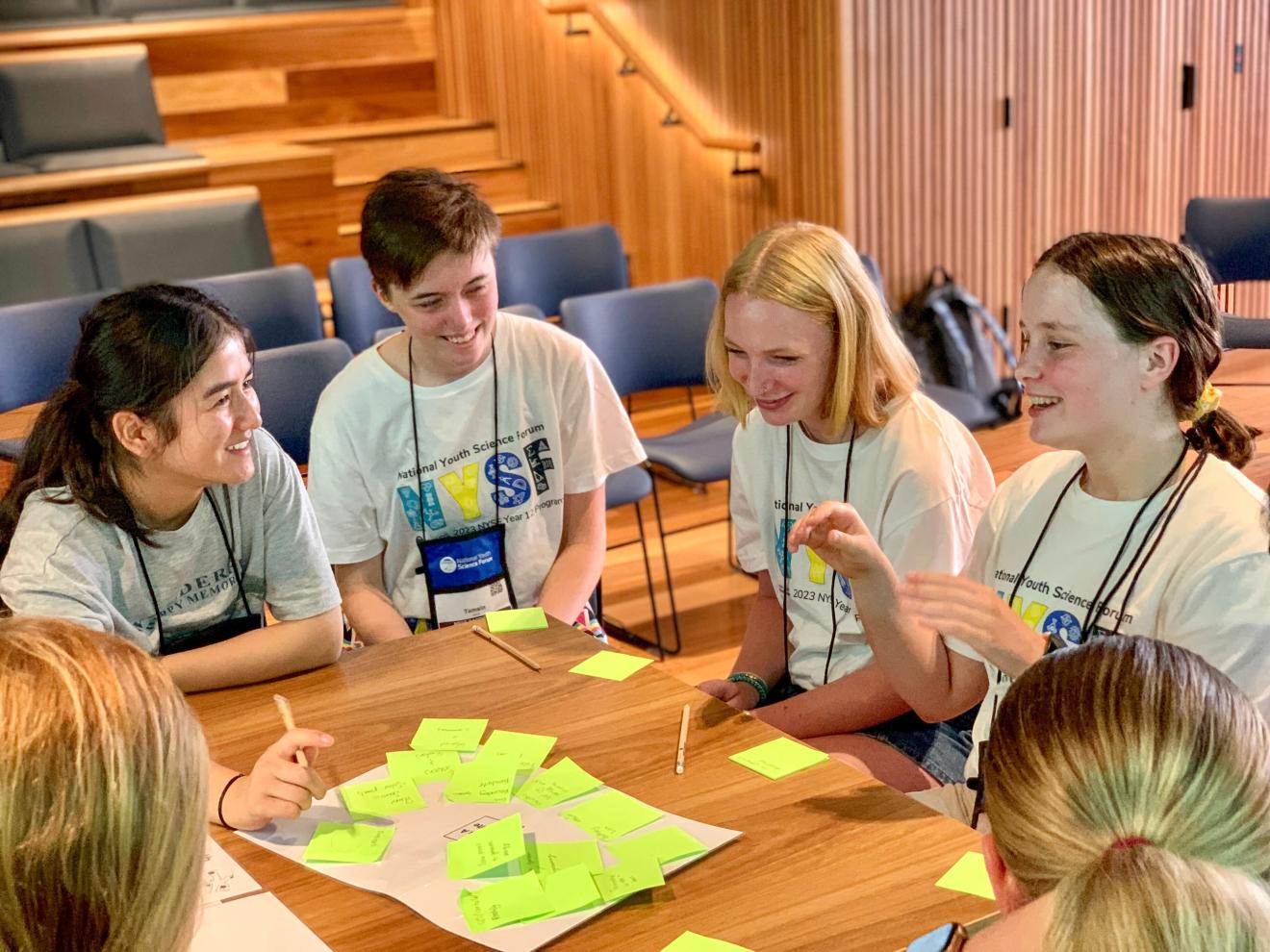 School kids around table in an engaging conversation