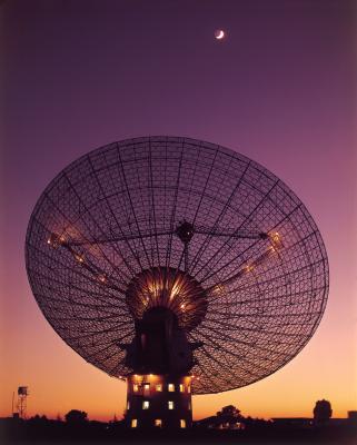 Satellite dish against bright purple sky