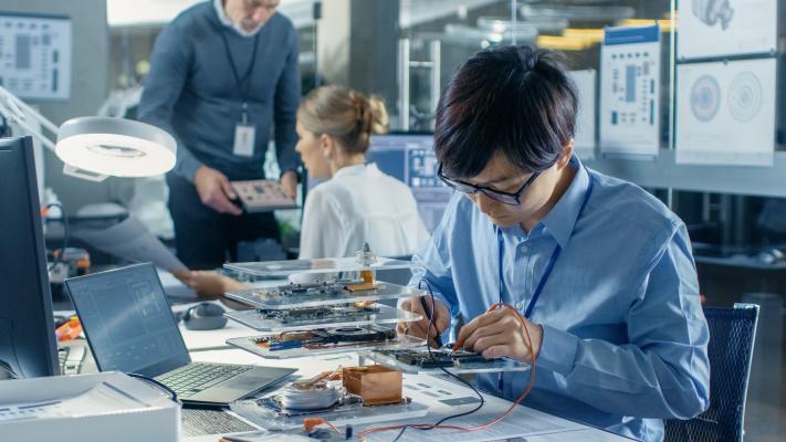 Electrical engineer Examines Circuit Board