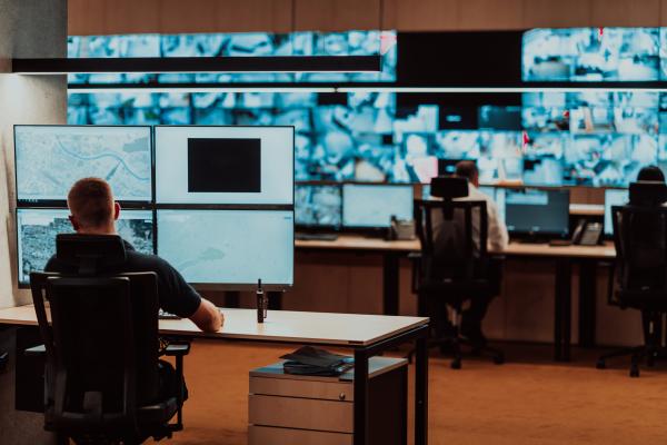 Operations room - people sit behind desks with many screens