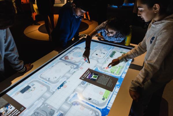 child playing on a large interactive touch screen