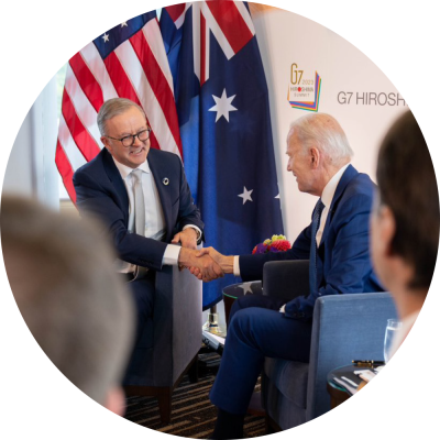 Two people shaking hands over an international agreement.