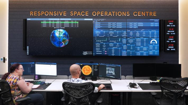 A group of people in a mission control.