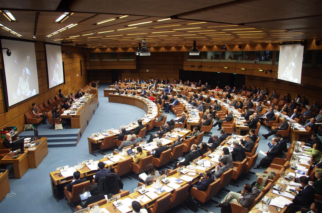 A large room with a semi circle of desks in four rows