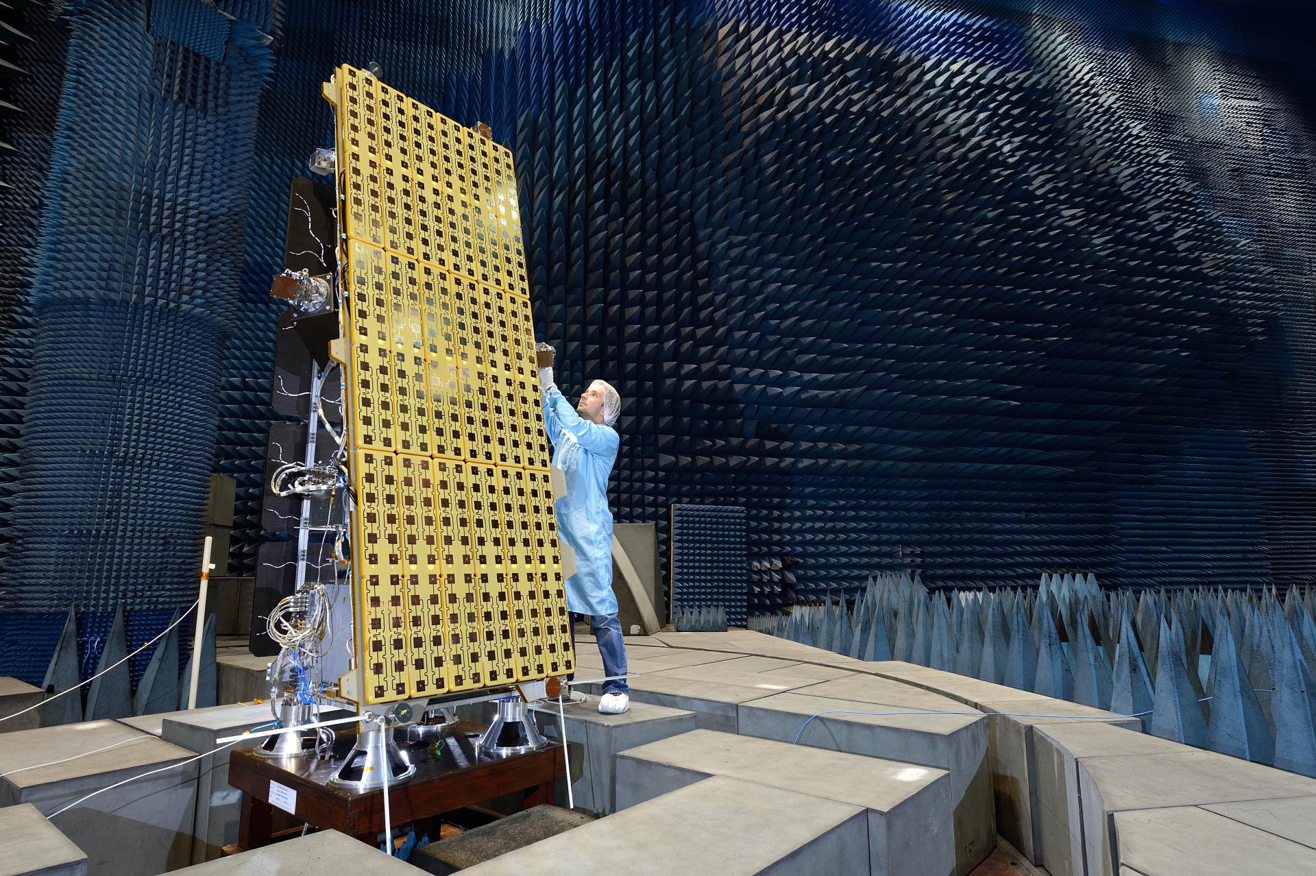 Scientist tests of space device in large sound proof room