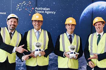 Leaders from state and federal government pose for photos with hard hats on